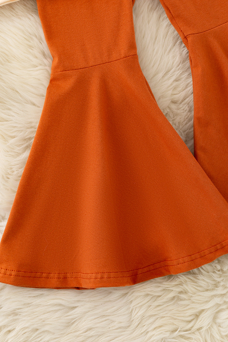 Pearl Bow printed on cream sweatshirt w/ ruffle and rust orange bell bottoms. OFG61417 SOL