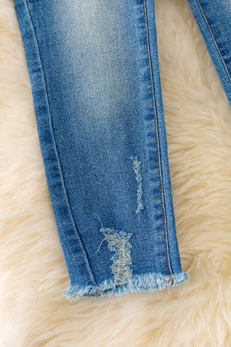 Bleached skinny jeans with distressed hem.