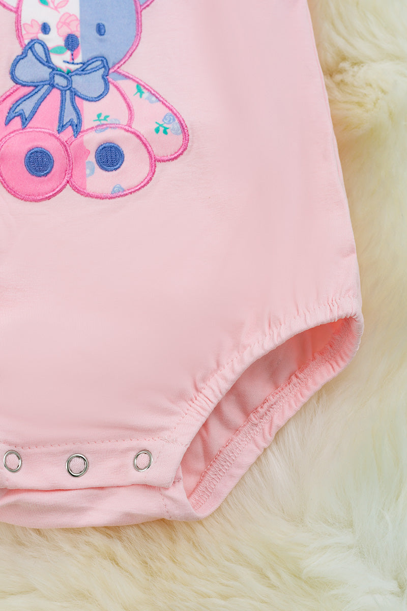 Teddy applique on pink onesie.