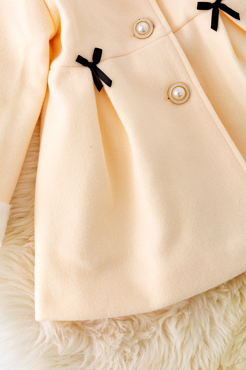 Ivory lined jacket with cozy fur trim.