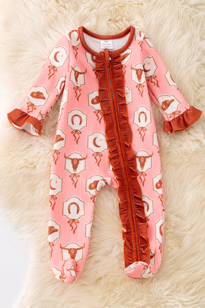 Bull skull printed on pink baby onesie with ruffle hem.