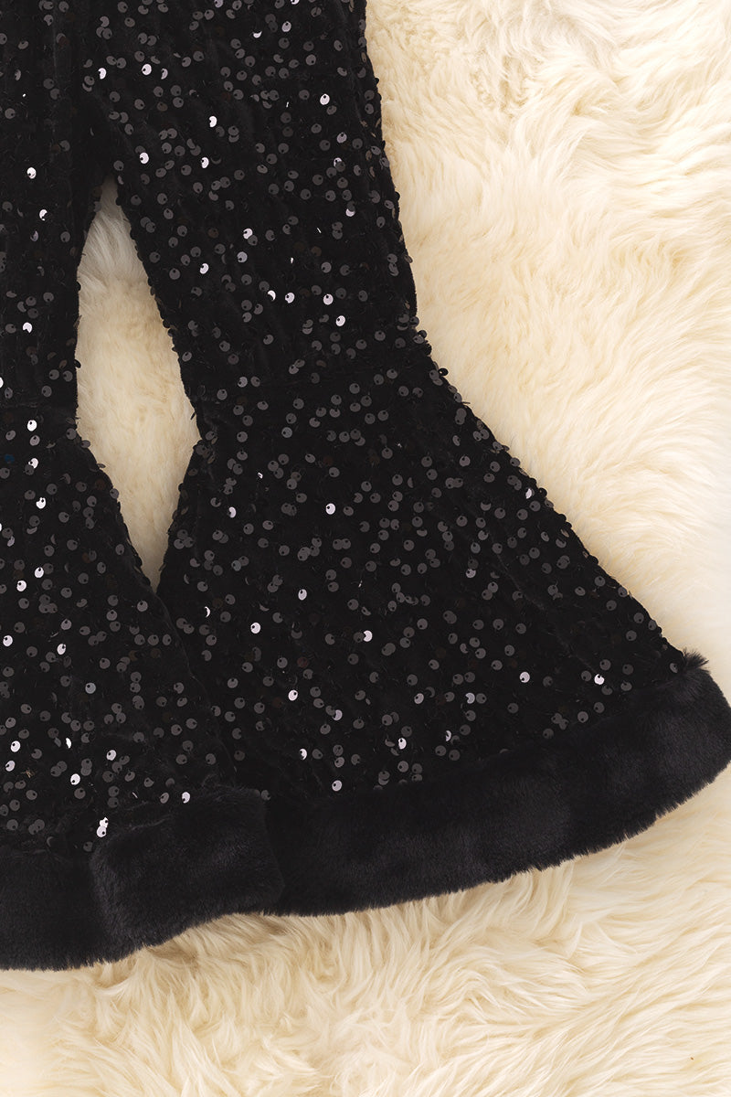 Black sequins bell bottoms with fur trim.