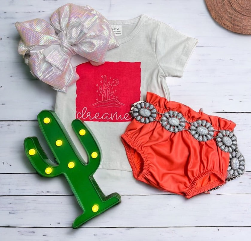 CORAL RUFFLE HEM BABY BLOOMERS. PNG25153120