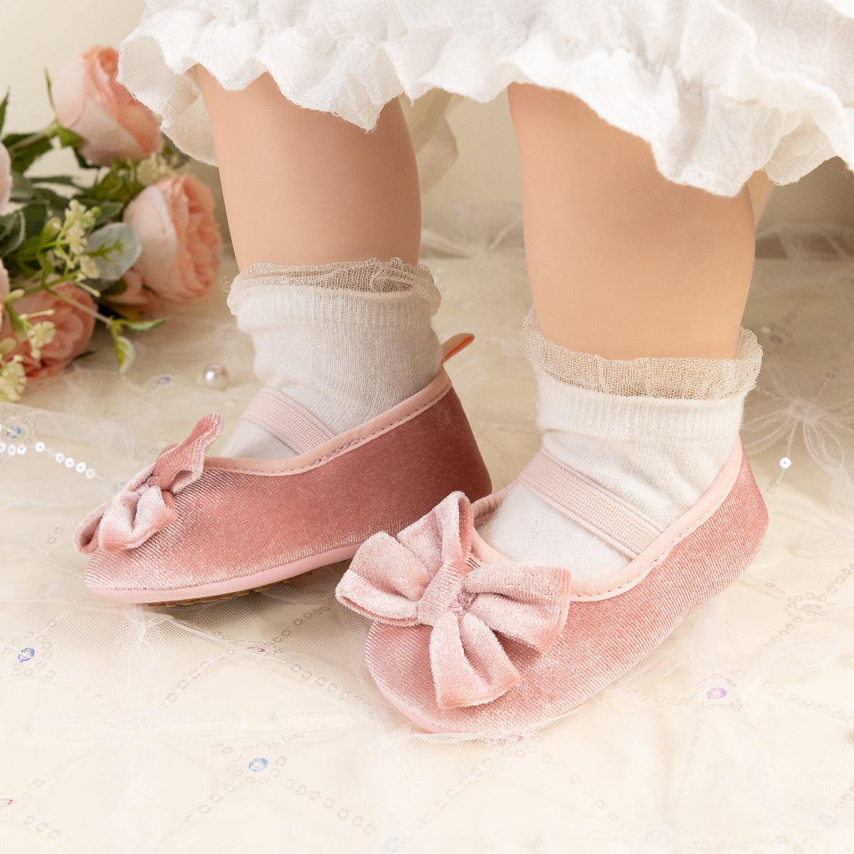 Front Bow velvety baby shoes, available in black and pink.
