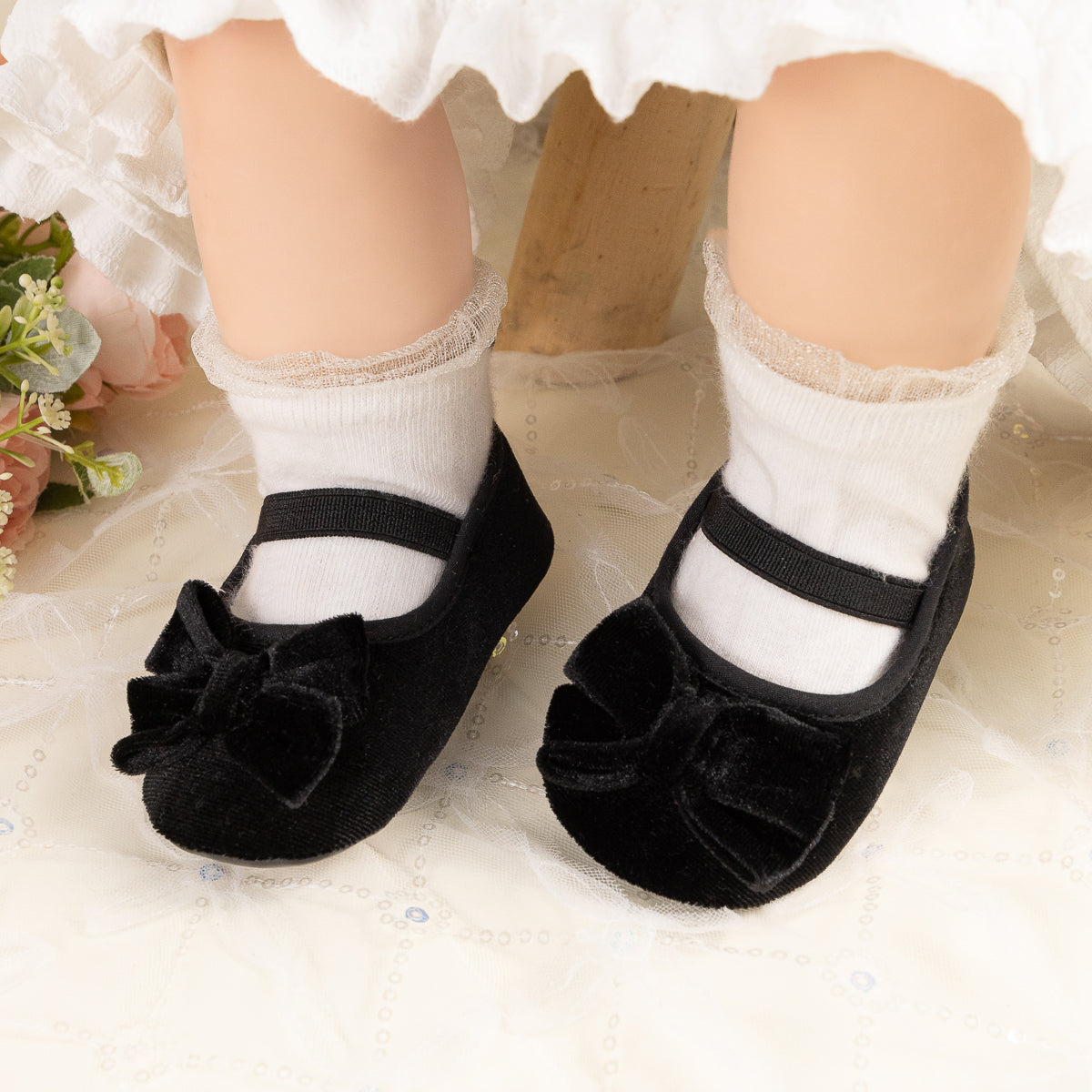 Front Bow velvety baby shoes, available in black and pink.
