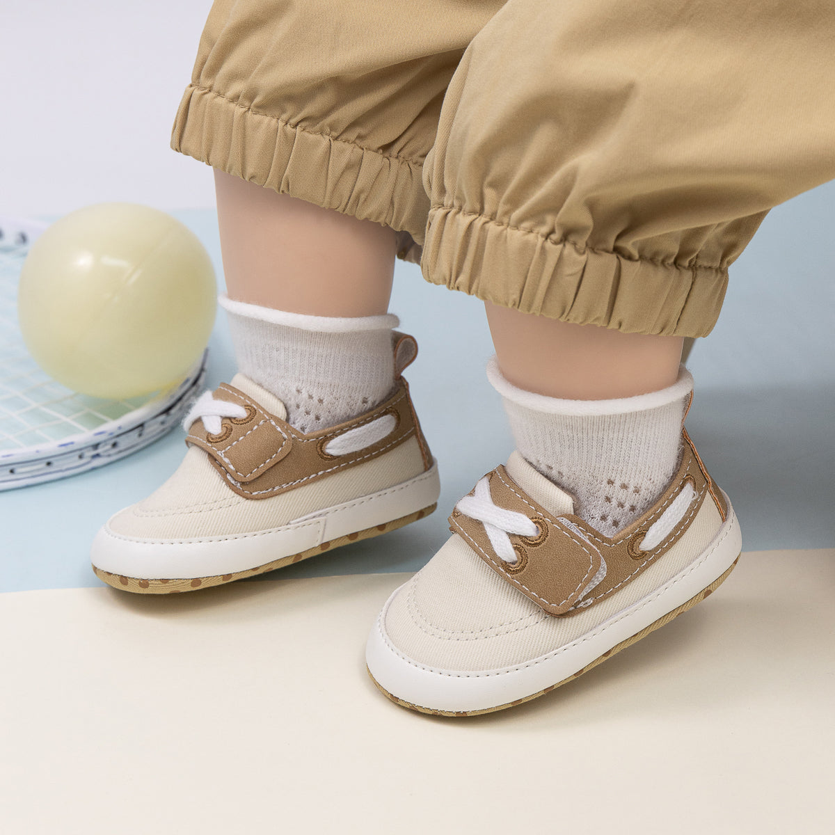 Cream canvas and pleather baby shoes. CG5167
