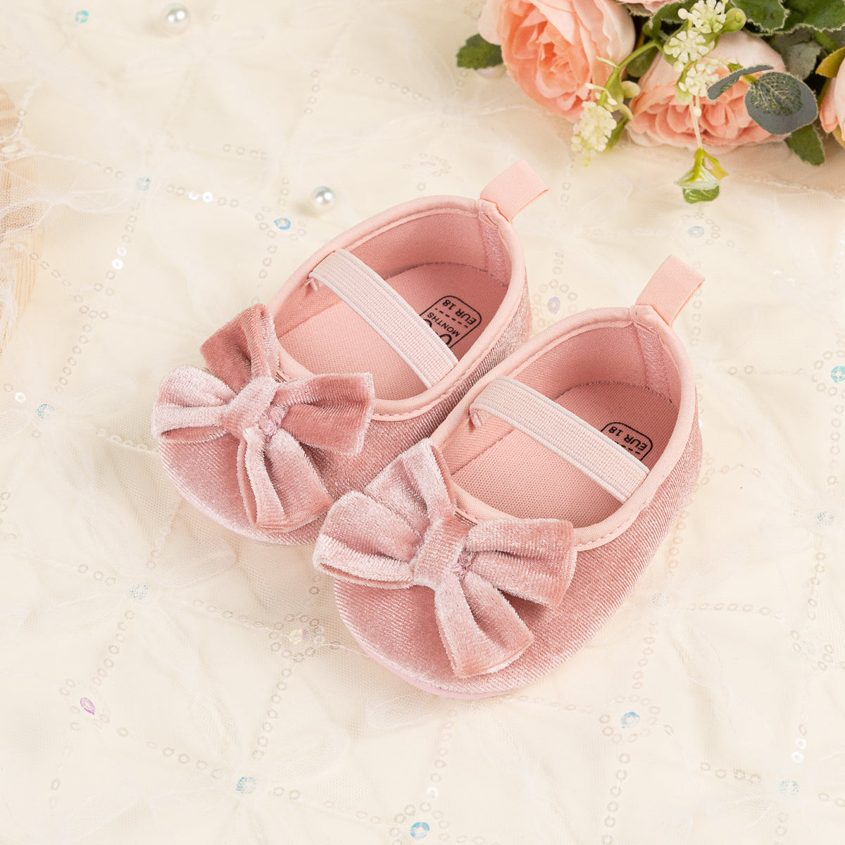Front Bow velvety baby shoes, available in black and pink.
