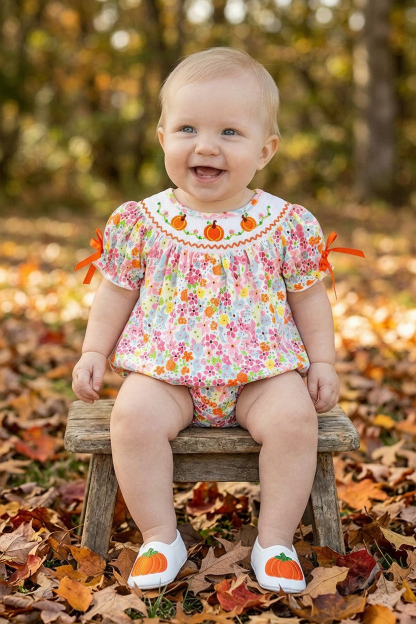 Floral smock baby romper with snaps. RPG62710