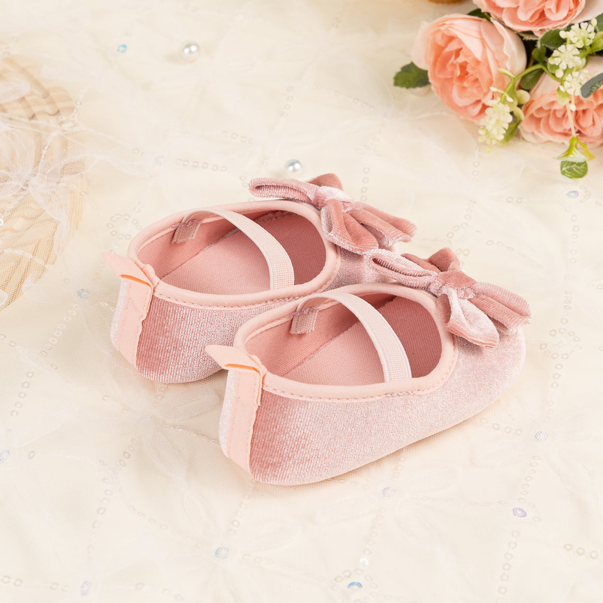 Front Bow velvety baby shoes, available in black and pink.
