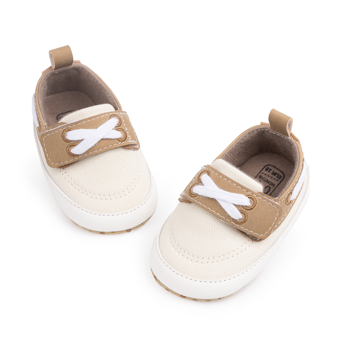 Cream canvas and pleather baby shoes. CG5167
