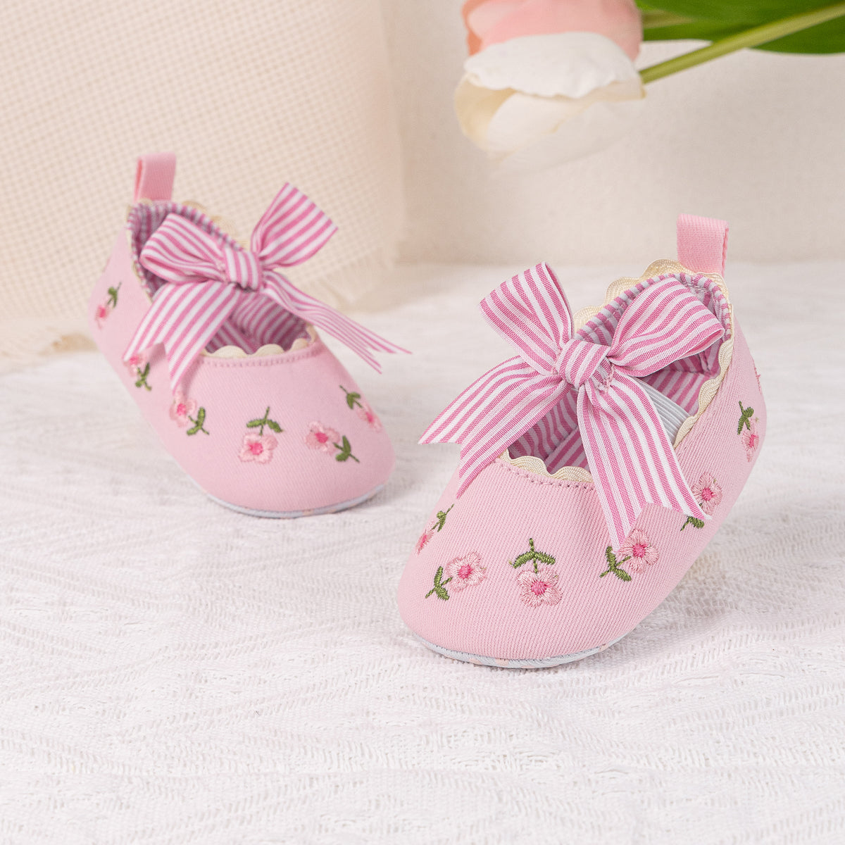 Embroidered girls baby shoes with front bow.