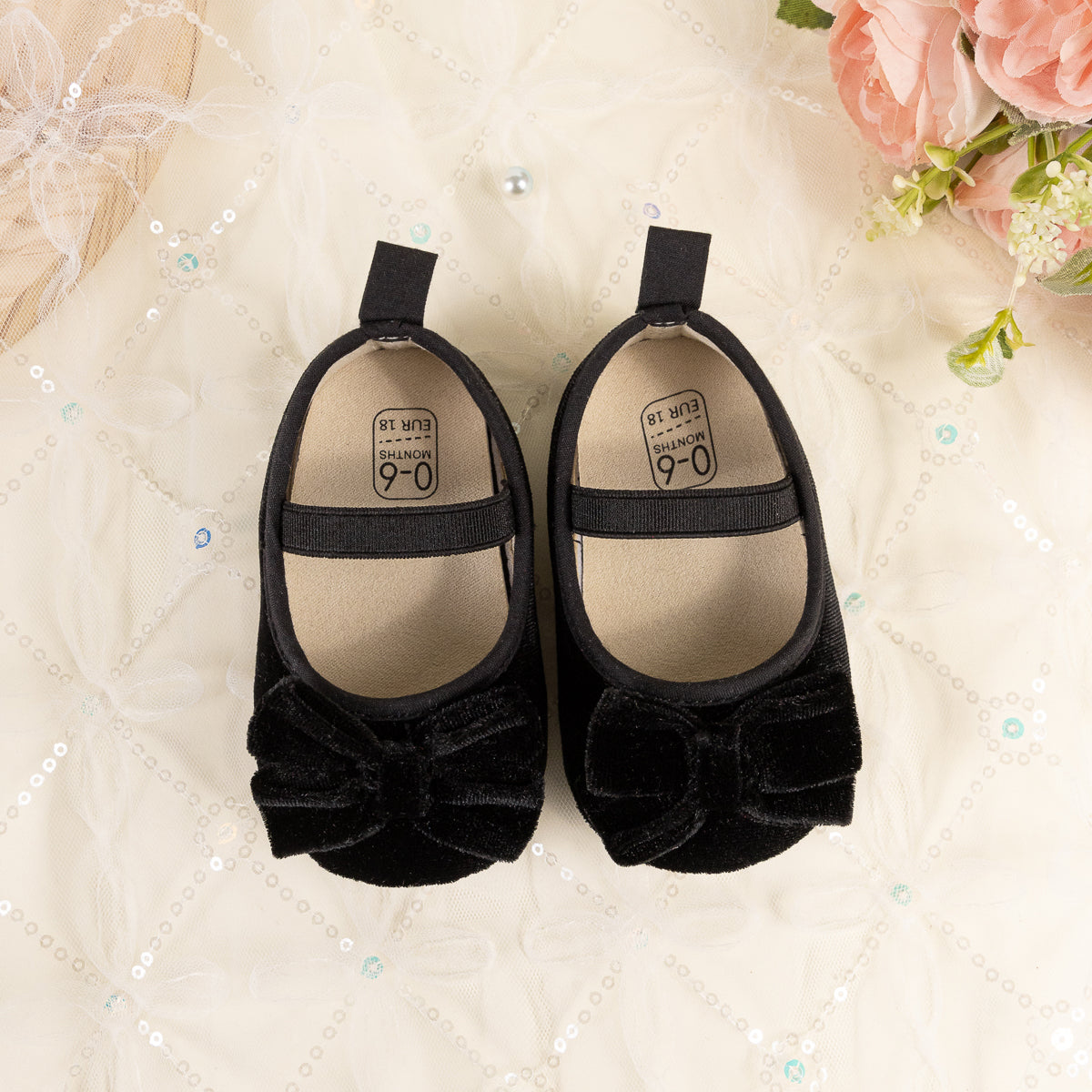 Front Bow velvety baby shoes, available in black and pink.
