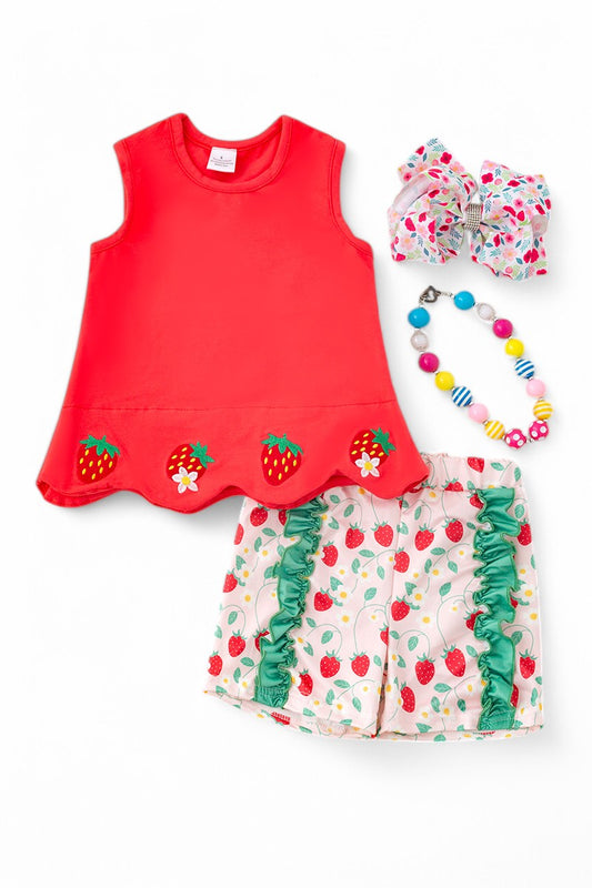 A red scalloped trim top paired with strawberry-printed shorts.