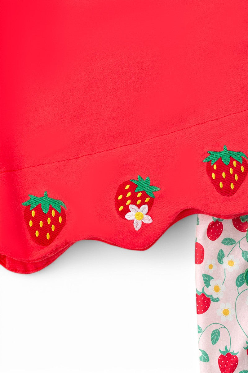 A red scalloped trim top paired with strawberry-printed shorts.