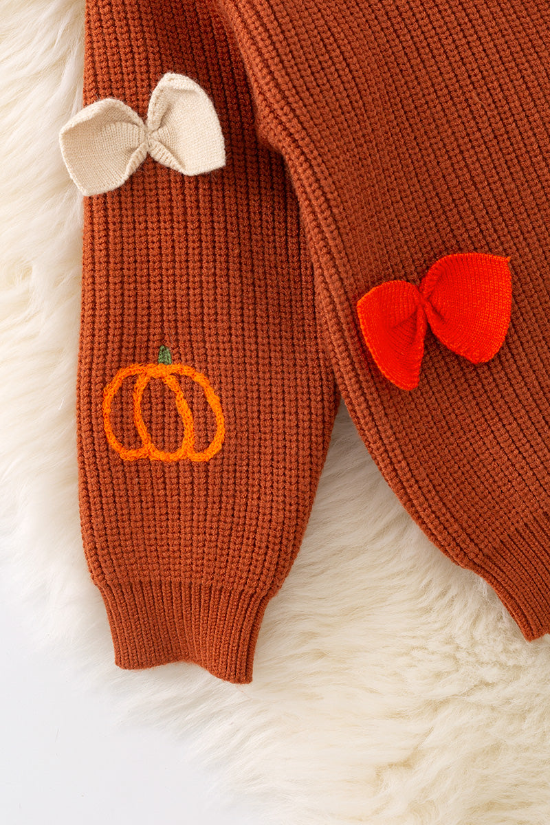 Brown pumpkin and bow knit pullover sweater.