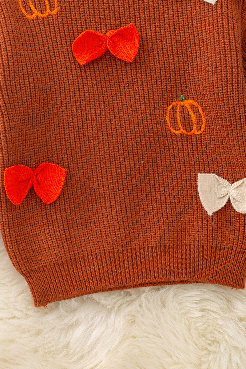 Brown pumpkin and bow knit pullover sweater.