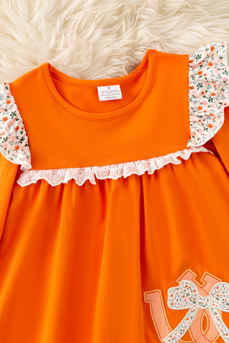 Orange Shoe horse applique tunic and floral pants. OFG61401