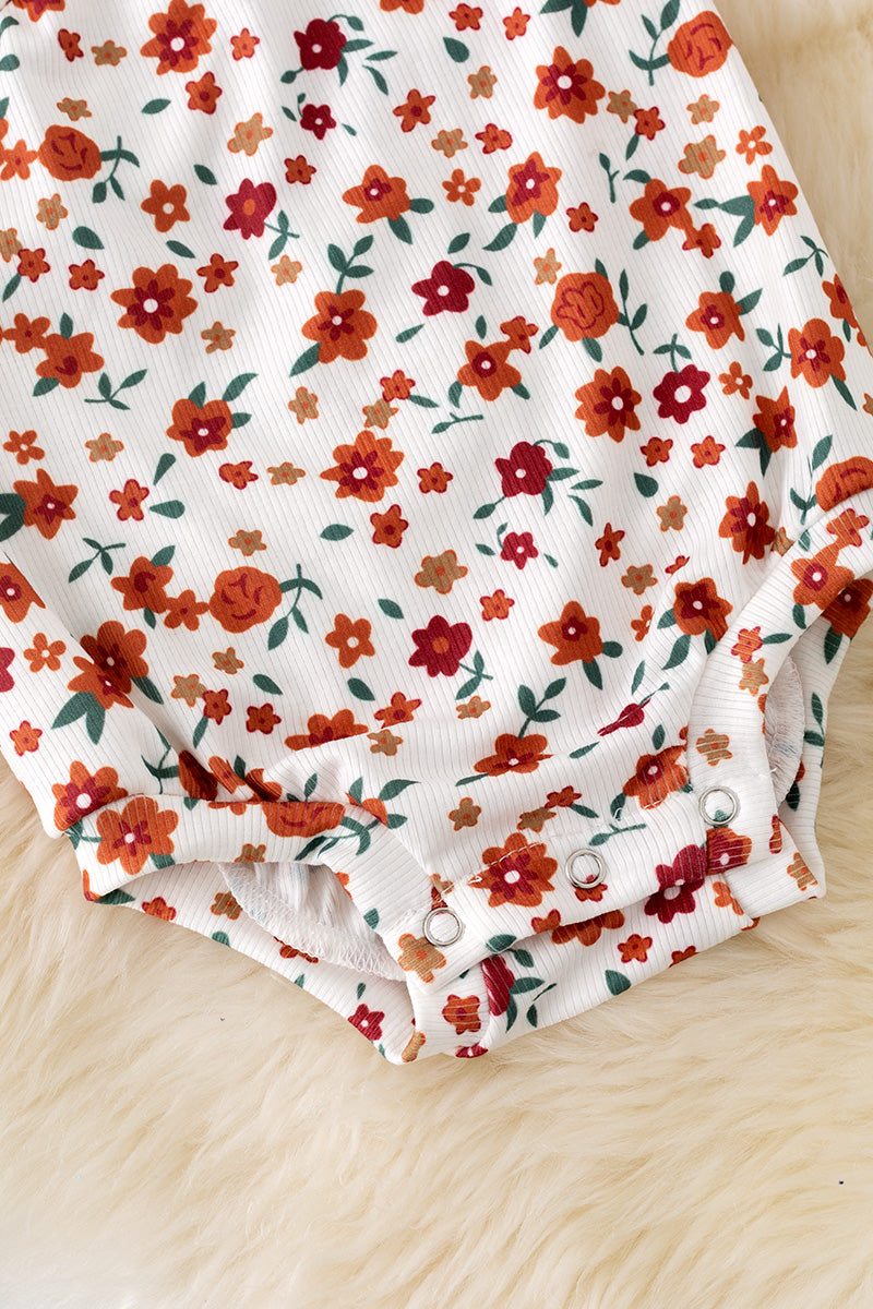 Cold shoulder ditsy floral bodysuit with snaps.