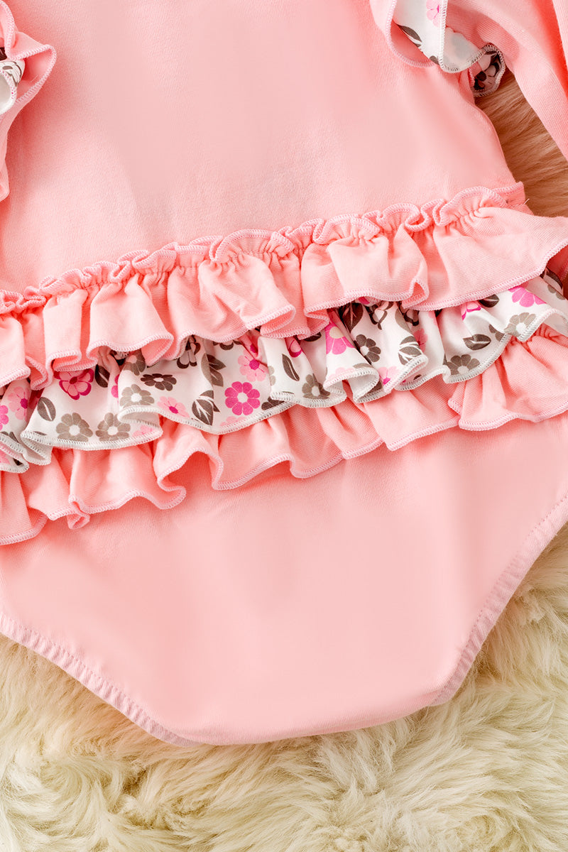 Pink cow applique baby bodysuit with floral ruffle on sleeves and ruffle butt. RPG61924 SOL
