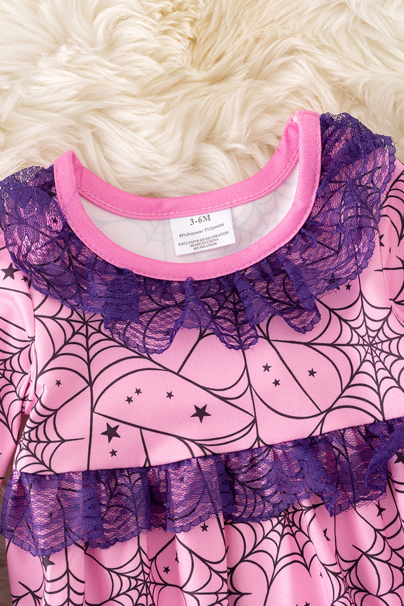 Spider web printed on pink baby onesie with purple lace and bell sleeves.