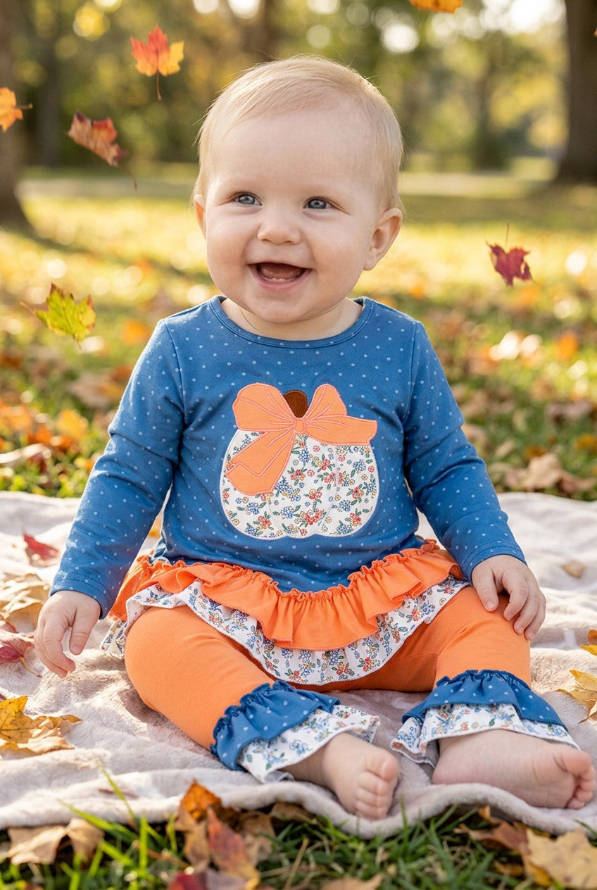Blue top w/white polka dot & ruffle hem and orange pants. OFG61765