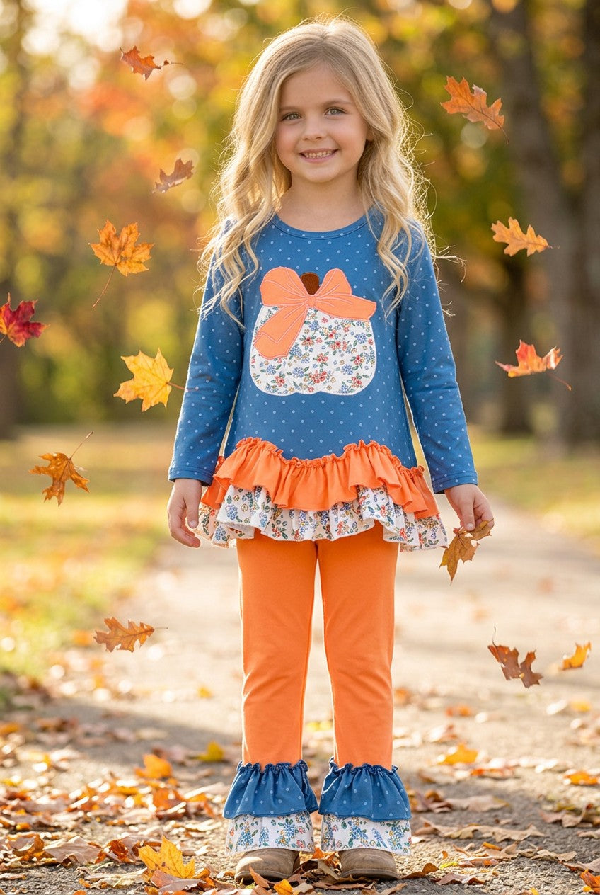 Blue top w/white polka dot & ruffle hem and orange pants. OFG61765