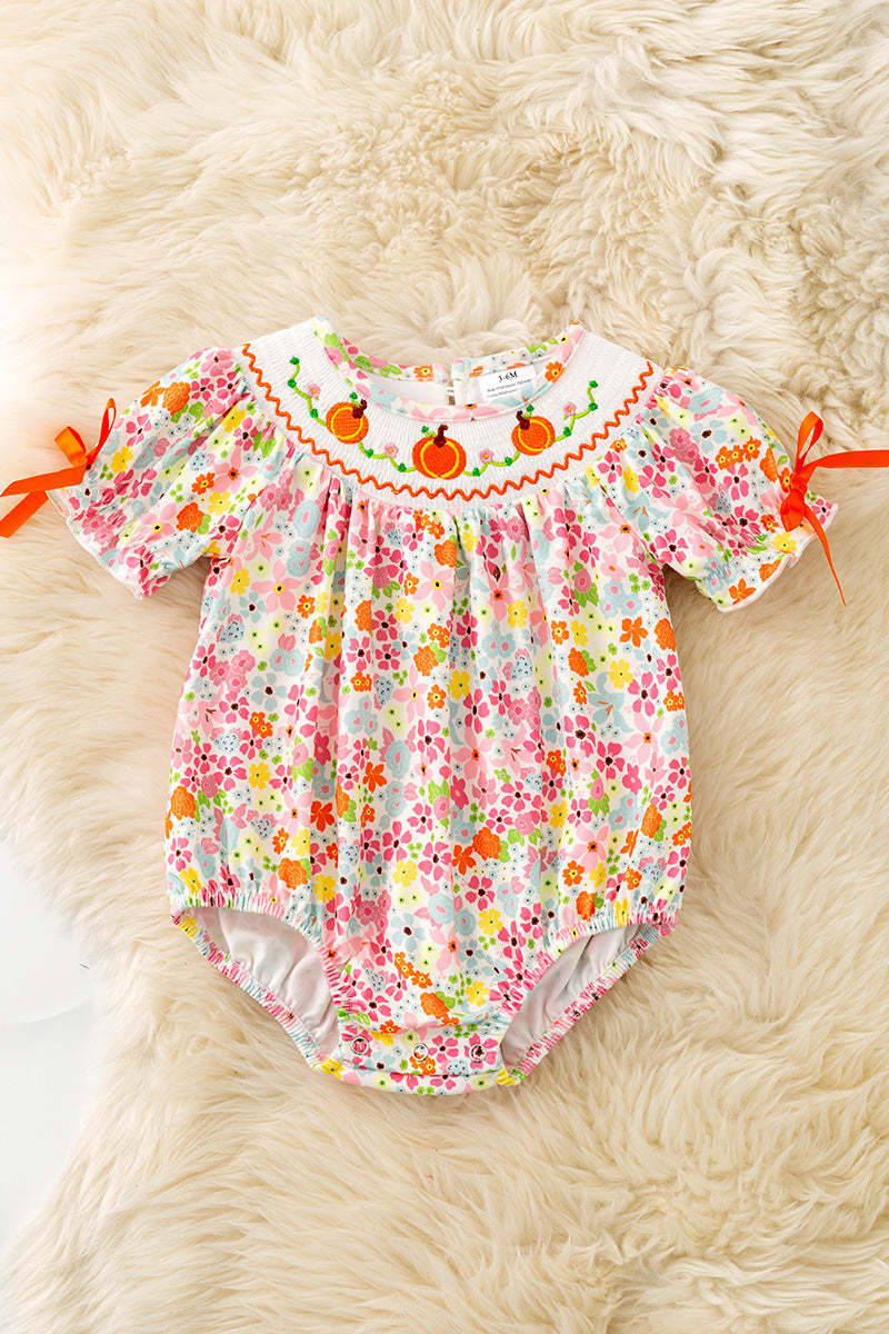 Floral smock baby romper with snaps. RPG62710