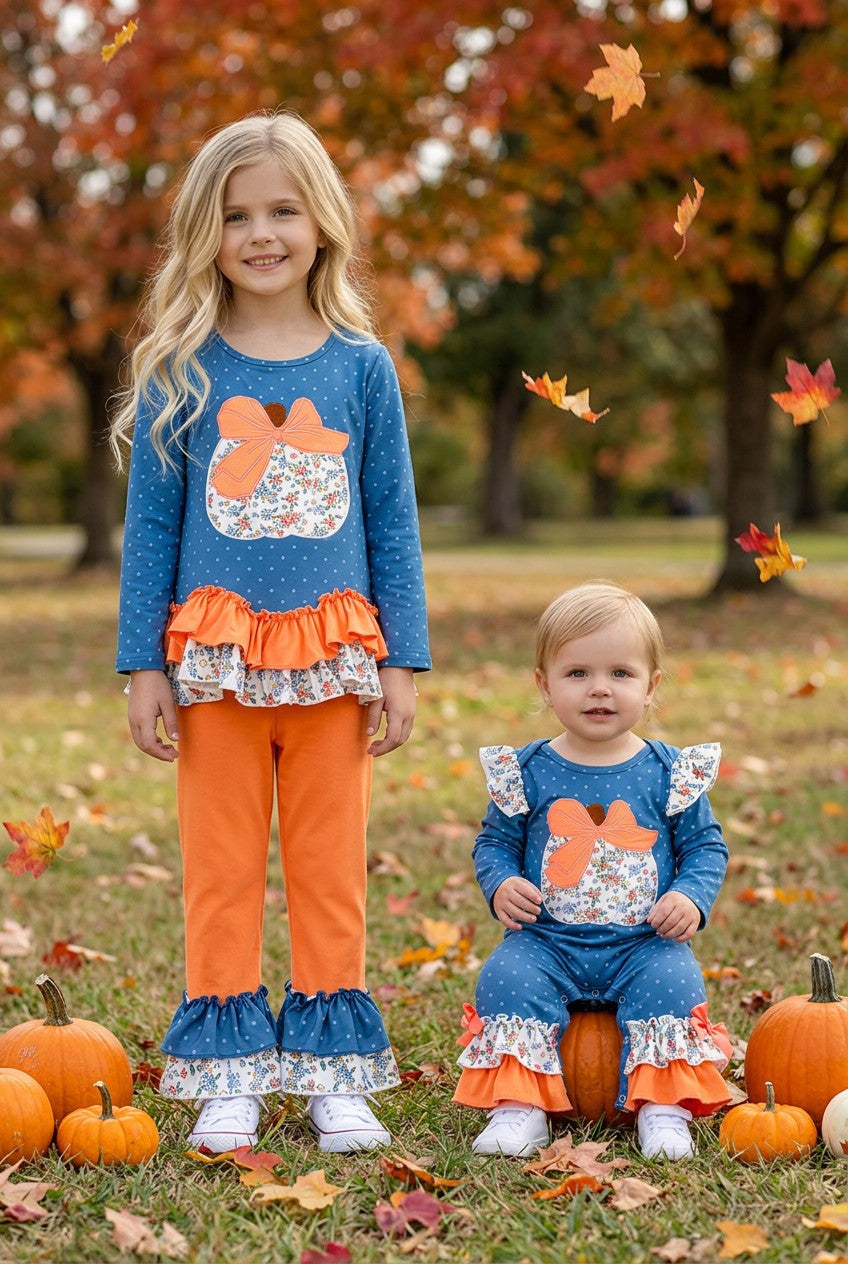 Blue top w/white polka dot & ruffle hem and orange pants. OFG61765