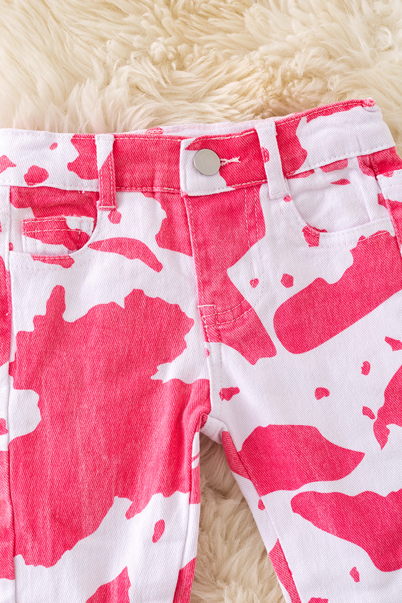 Pink cow spotted denim bell pants with adjustable waistband.