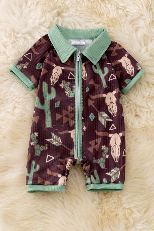 Bull skull & cactus printed on brown baby romper with green trim. RPB50494