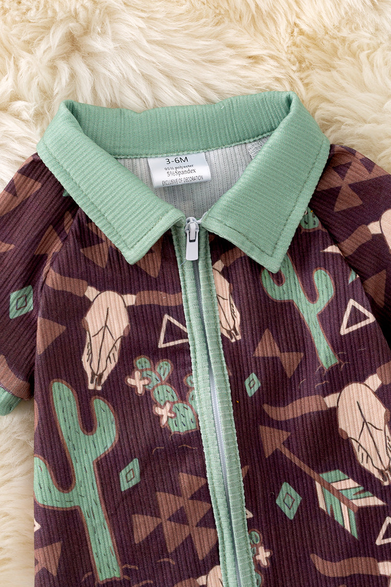 Bull skull & cactus printed on brown baby romper with green trim. RPB50494