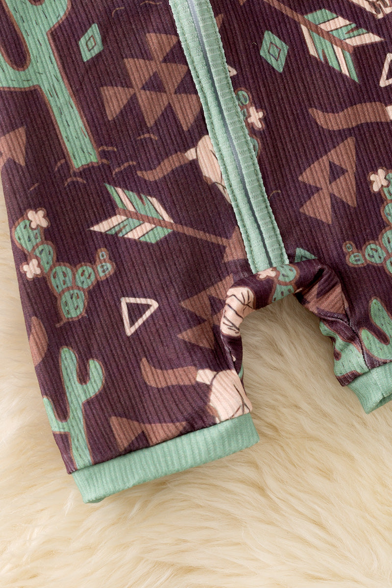 Bull skull & cactus printed on brown baby romper with green trim. RPB50494