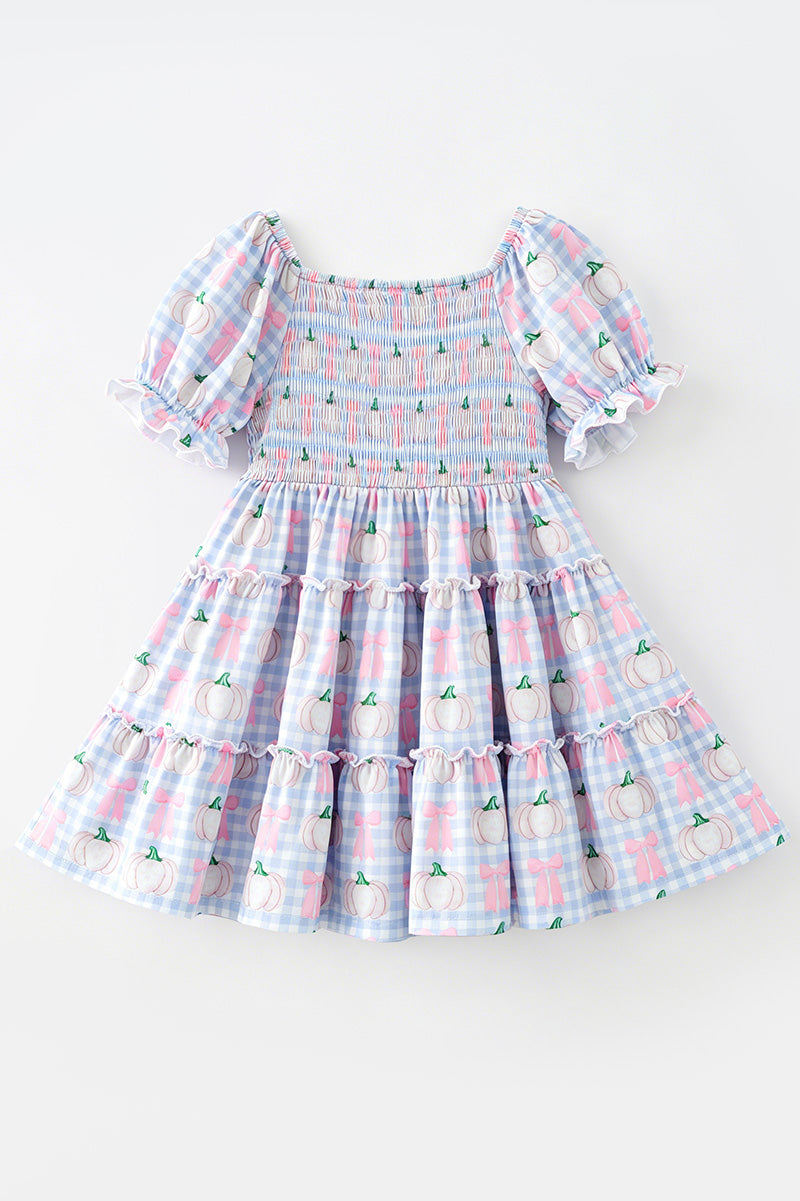 Blue gingham w/ pumpkin printed smocked tiered dress. DRG65299 SOL