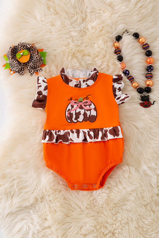 Cow printed pumpkin baby onesie.