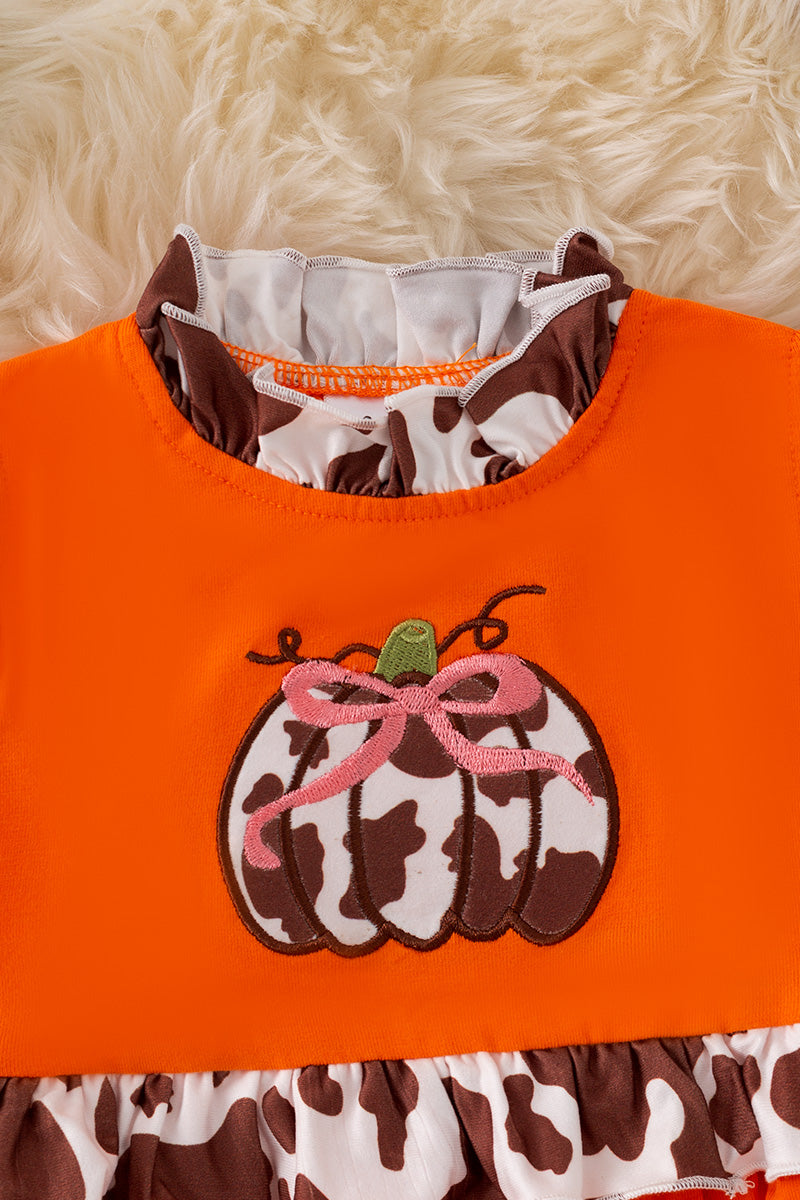 Cow printed pumpkin baby onesie.