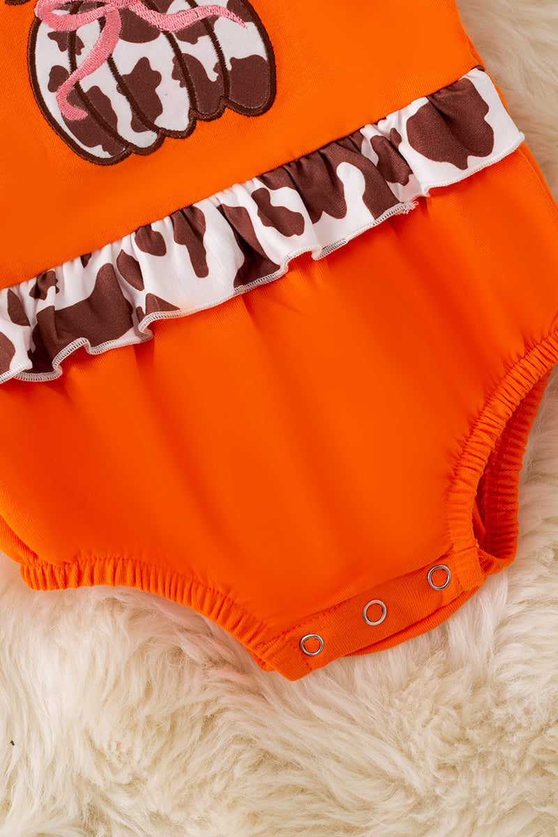 Cow printed pumpkin baby onesie.