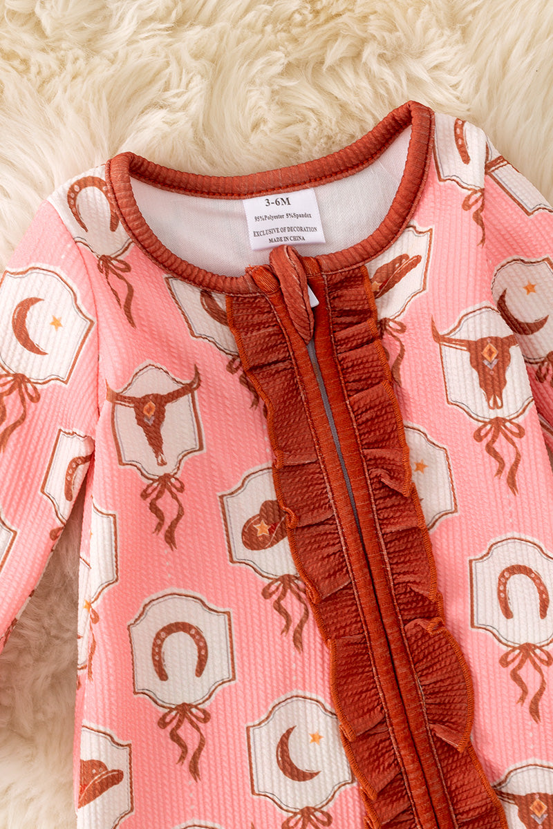 Bull skull printed on pink baby onesie with ruffle hem.