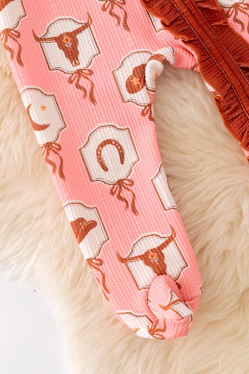 Bull skull printed on pink baby onesie with ruffle hem.