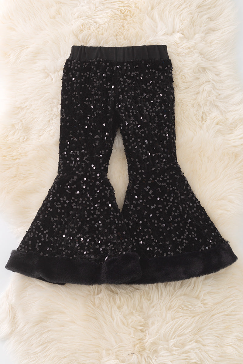 Black sequins bell bottoms with fur trim.