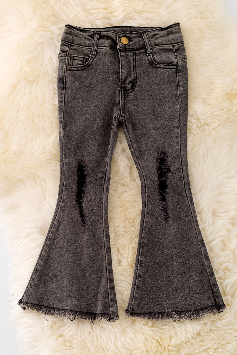 Black distressed denim pants with a bootcut.