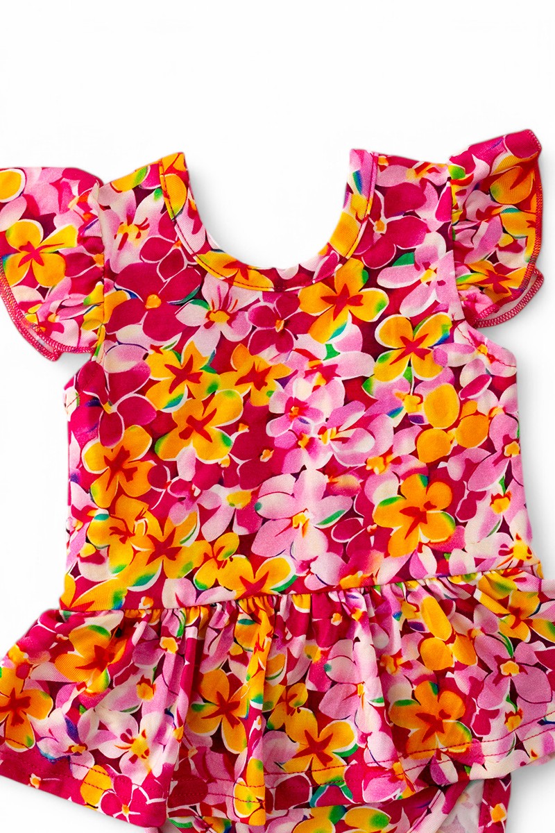 Multi-Printed girls baby onesies with snaps.