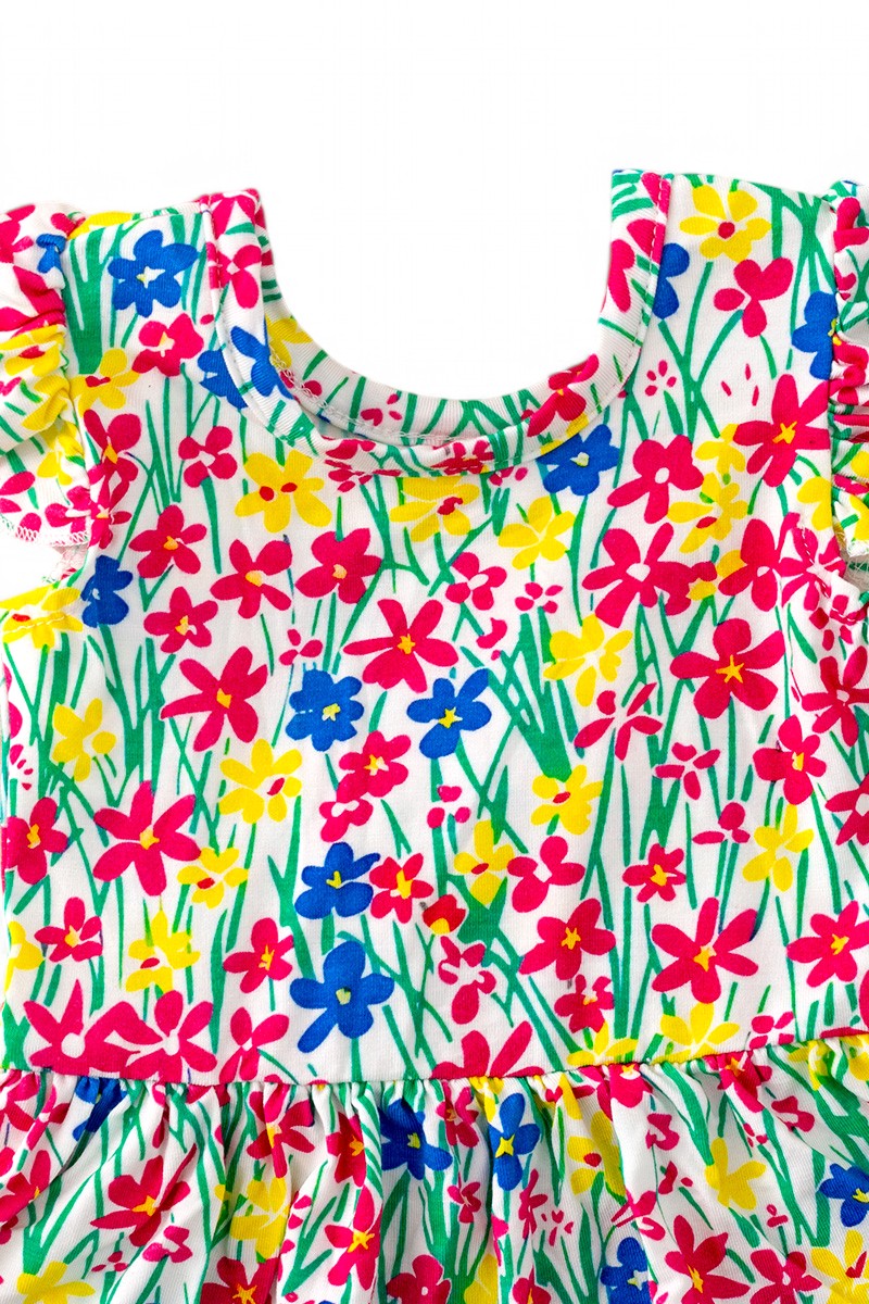 Multi-Printed girls baby onesies with snaps.