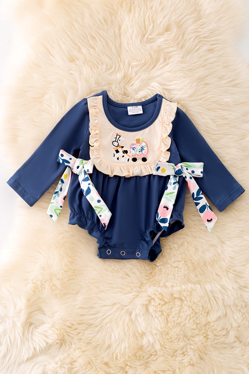 Navy blue cow applique baby onesie with snaps.