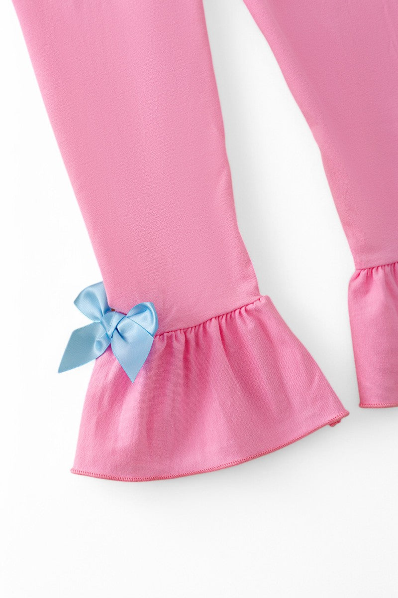 Pink character printed tunic & ruffle pants with blue bow & ruffle trim.