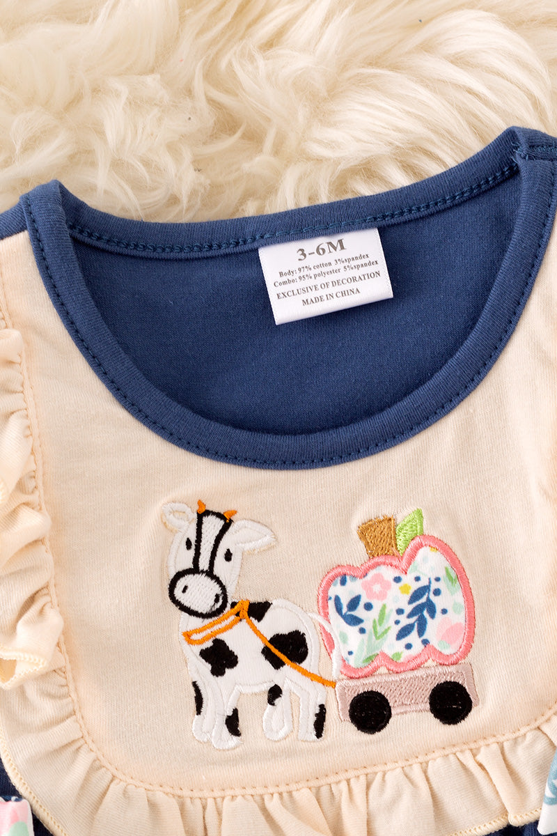 Navy blue cow applique baby onesie with snaps.
