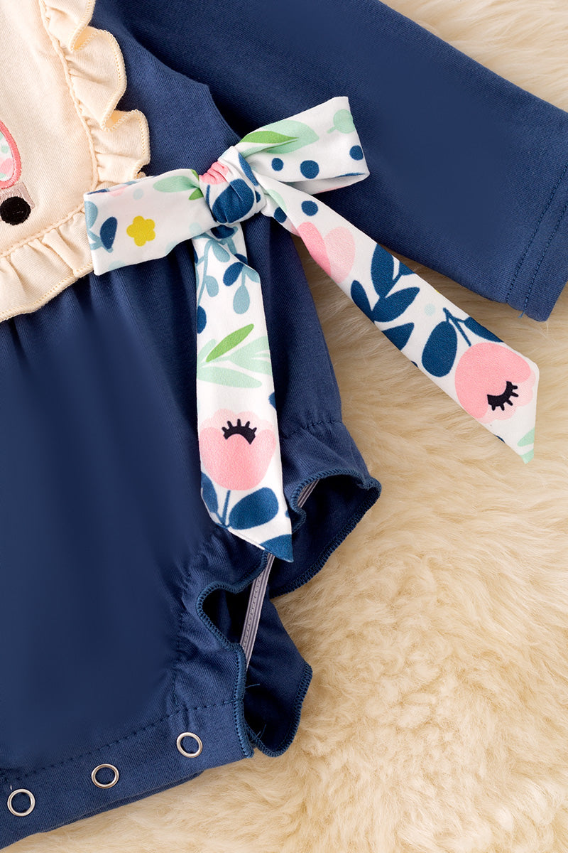 Navy blue cow applique baby onesie with snaps.