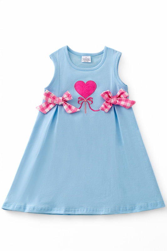 Fuchsia heart application on blue cotton dress.