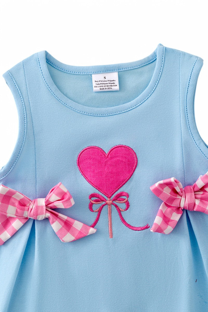 Fuchsia heart application on blue cotton dress.