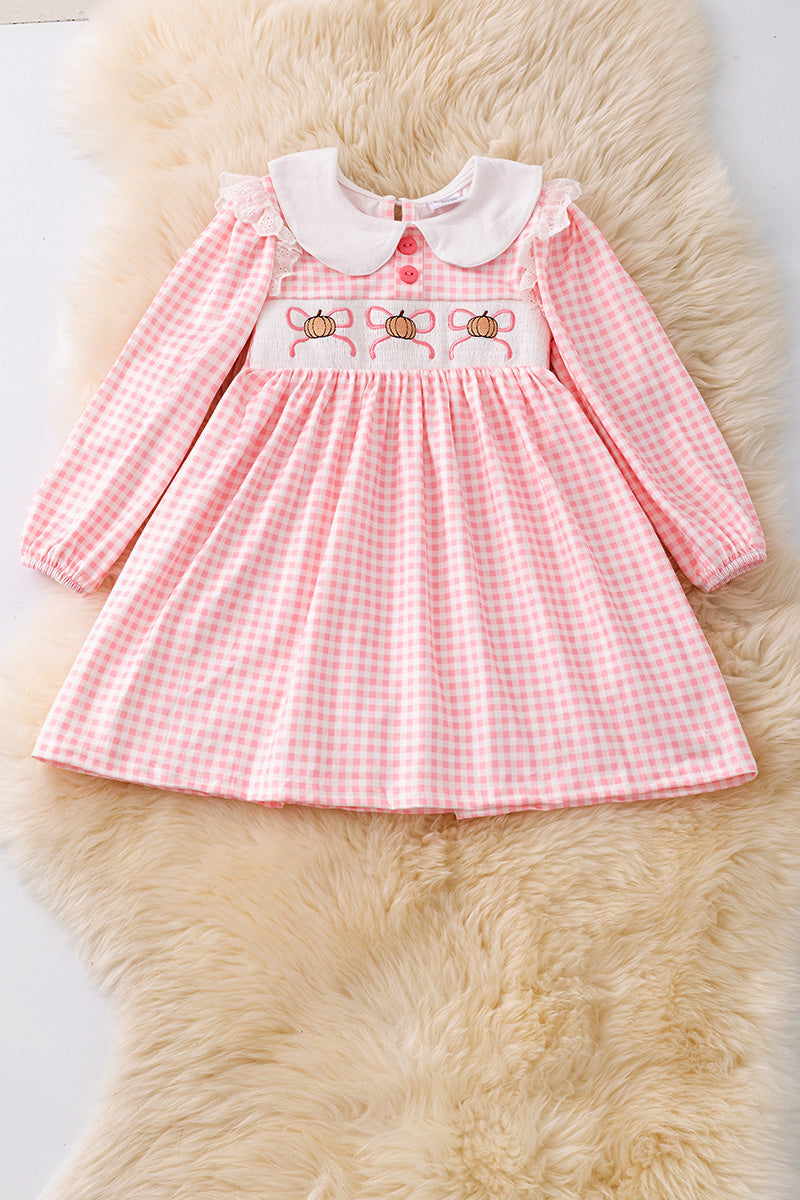 Checkered printed girls dress with pumpkin/bow embroidery. DRG53049