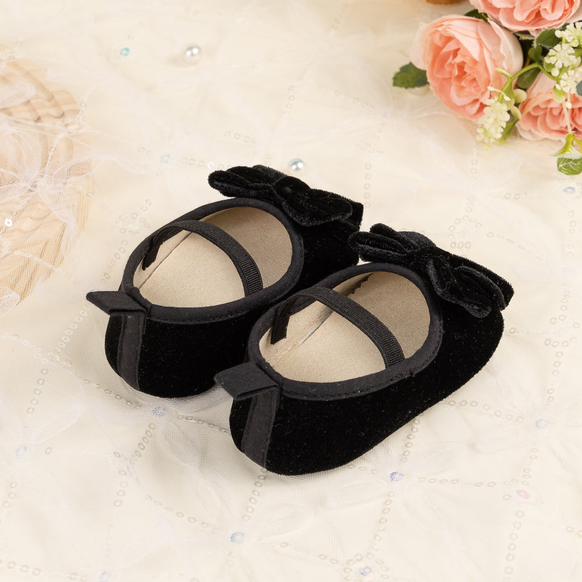 Front Bow velvety baby shoes, available in black and pink.